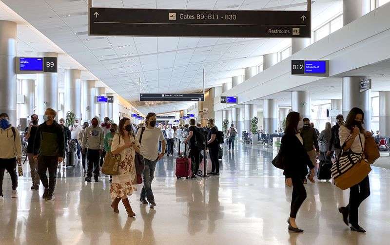 Travelers walk through Salt Lake City International Airport in Salt Lake City on Monday, May 3, 2021.