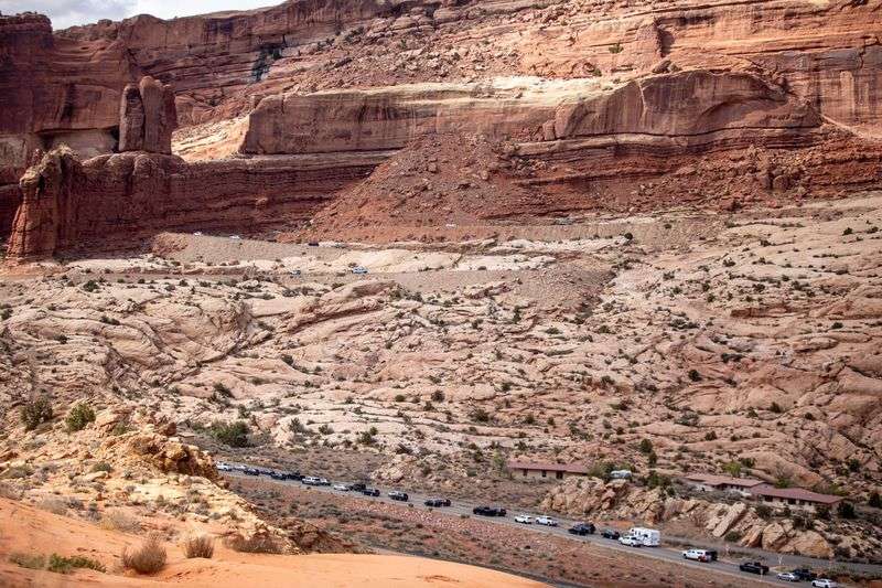 Tourists line up to enter Arches National Park in Moab
on Friday, April 16, 2021.