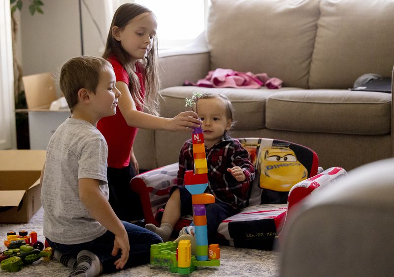 Ryan, Lily and Luke Mackie play with blocks at their
home in Provo on Wednesday, April 28, 2021.