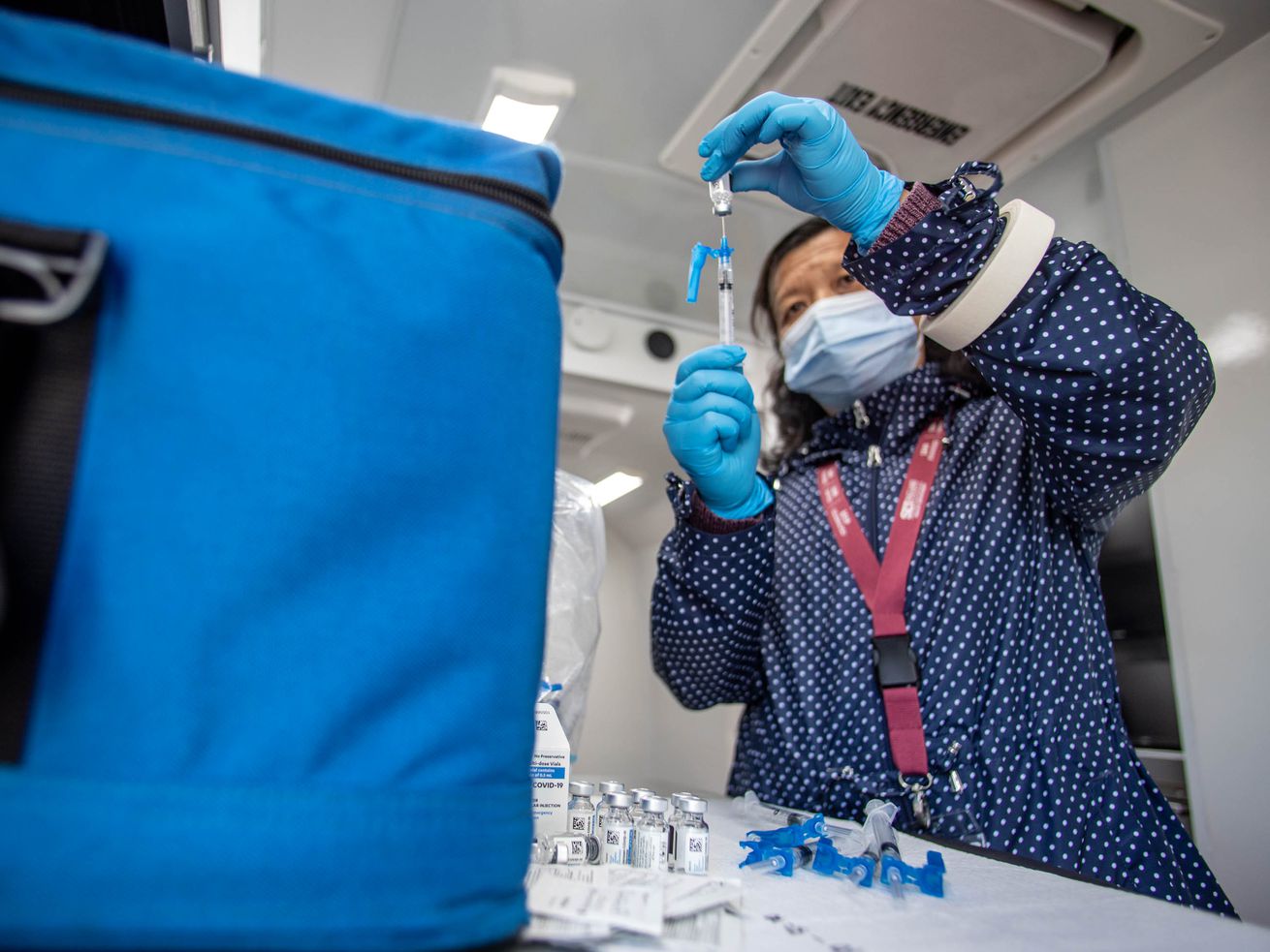 Health care worker Qing Chong prepares COVID-19
vaccines for a pop-up vaccination event at Reams in Magna on
Monday, May 3, 2021. The Salt Lake County Health Department is
doing vaccination pop-up events with its mobile health center.