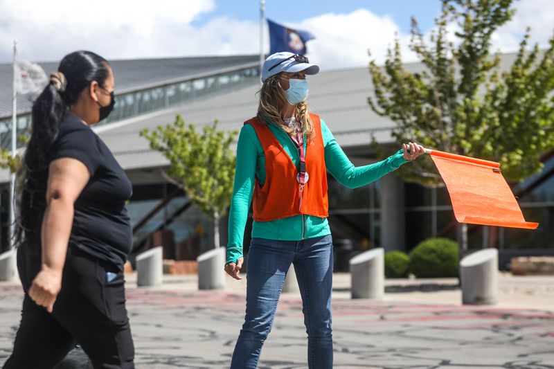 Volunteer Marilyn Hampton, right, directs foot and
vehicle traffic at Mountain America Expo Center in Sandy on Monday,
May 3, 2021. The site previously had difficulty securing doses of a
COVID-19 vaccine, but now has the ability to do walk up
vaccinations 10:00-2:00 Monday-Saturday instead of only by
appointment.
