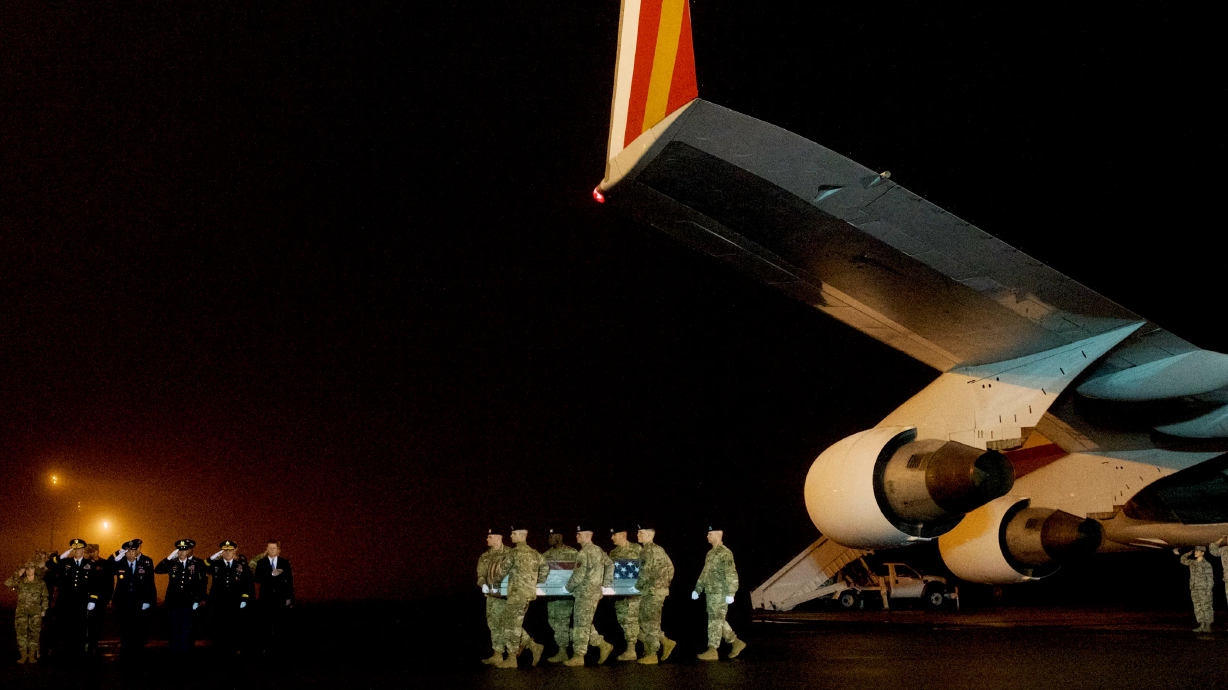 Officers carry Maj. Brent Taylor’s body off a plane at Dover Air Force Base in Delaware on Nov. 6, 2018.