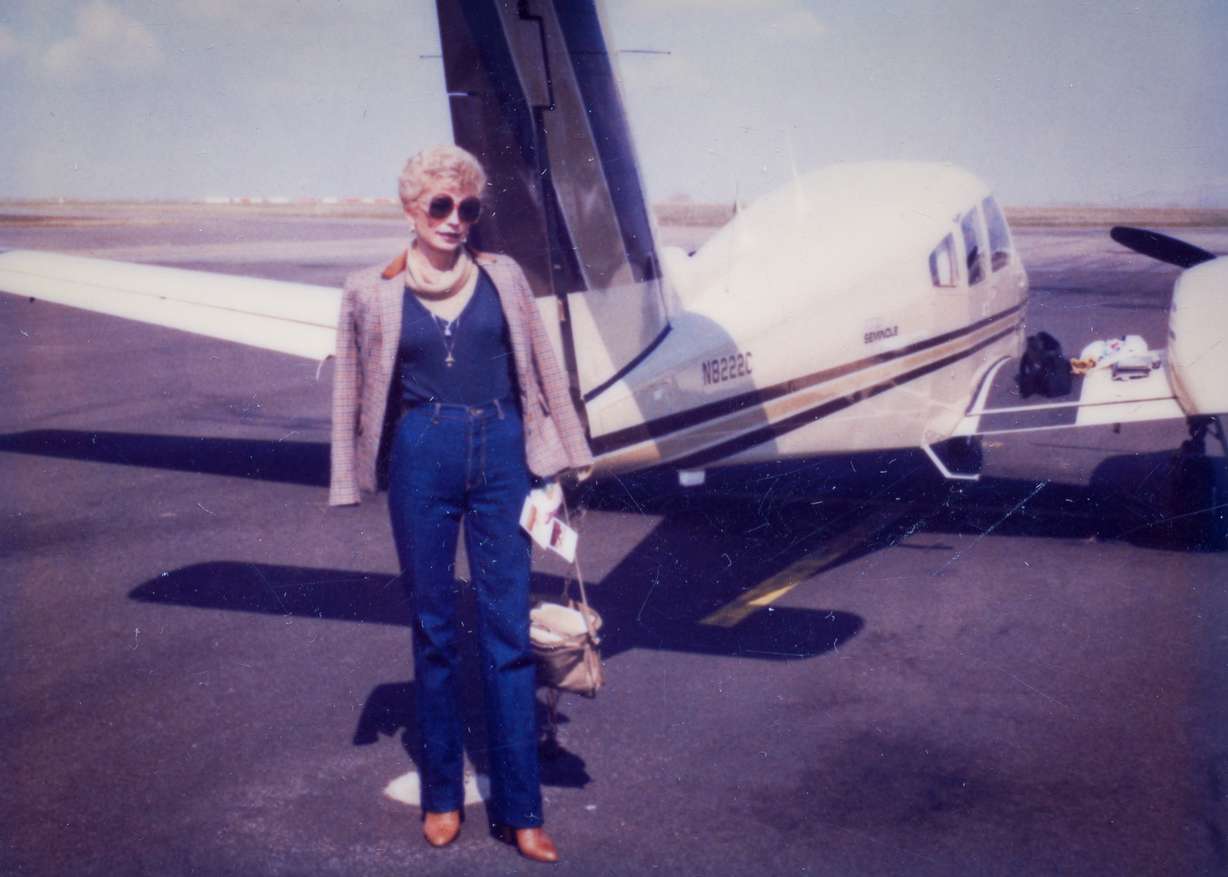 Joyce Yost stands next to a Piper PA-44 Seminole in this undated snapshot.