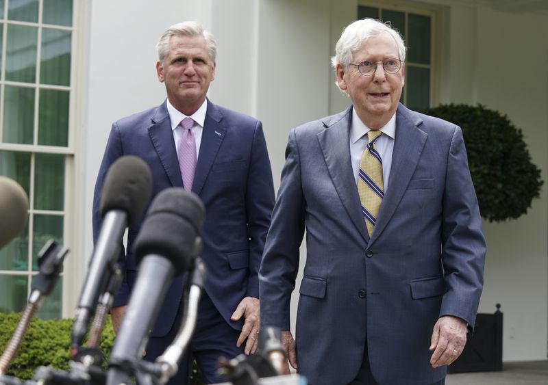 House Minority Leader Kevin McCarthy and Senate Minority Leader Mitch McConnell smile toward reporters following a meeting with U.S. President Joe Biden at the White House in Washington, U.S., May 12, 2021. REUTERS/Kevin Lamarque