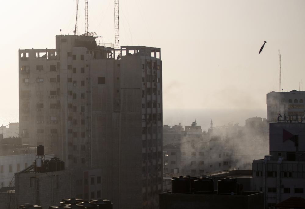 An Israeli missile flies down to hit a building in Gaza City, Wednesday, May 12, 2021. The Israeli airstrike was the latest in a series of assaults on targets in the Gaza Strip after a long dispute between Israel and Hamas erupted into an exchange of rocket attacks from Gaza and Israeli retaliation.