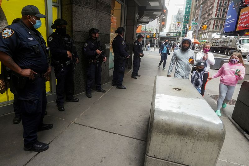 FILE PHOTO: New York City police officers stand in Times Square in the Manhattan borough of New York City, New York, U.S., May 10, 2021.  REUTERS/Carlo Allegri/File Photo