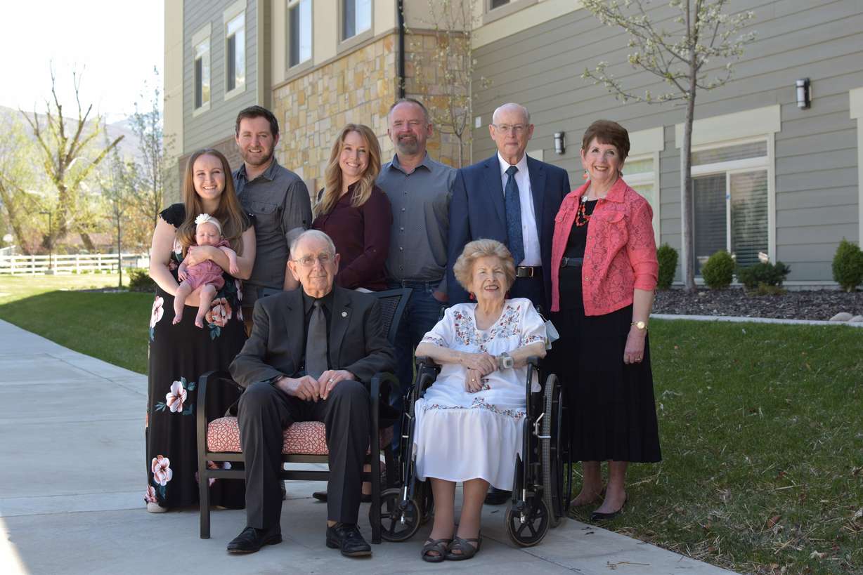 Four generations of married couples, along with a brand-new member of the family, join together for a rare family photo.