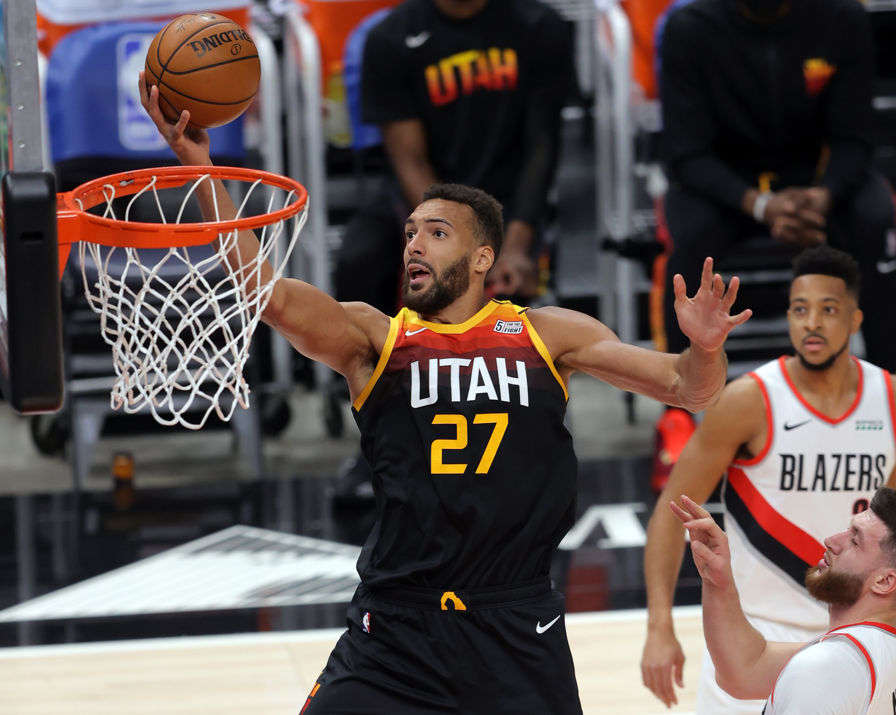 Utah Jazz center Rudy Gobert (27) flies in for a shot over Portland Trail Blazers center Jusuf Nurkic (27) as the Utah Jazz and the Portland Trail Blazers play an NBA basketball game at Vivint Arena in Salt Lake City on Wednesday, May 12, 2021.