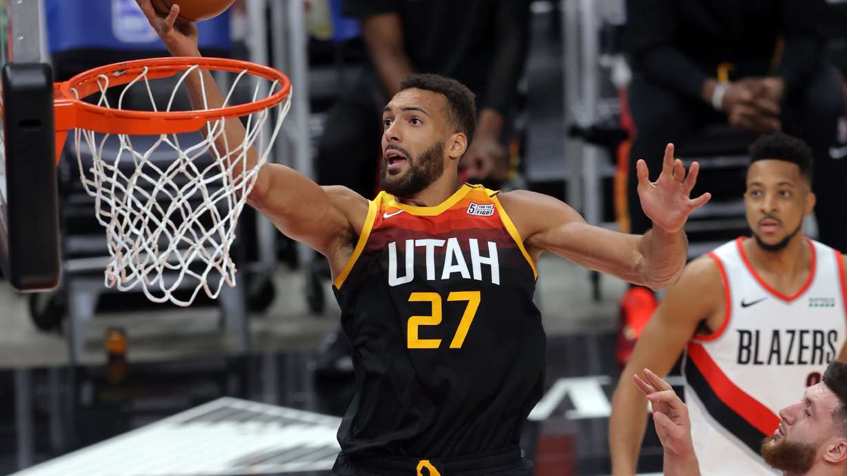 Utah Jazz center Rudy Gobert (27) flies in for a shot over Portland Trail Blazers center Jusuf Nurkic (27) as the Utah Jazz and the Portland Trail Blazers play an NBA basketball game at Vivint Arena in Salt Lake City on Wednesday, May 12, 2021.