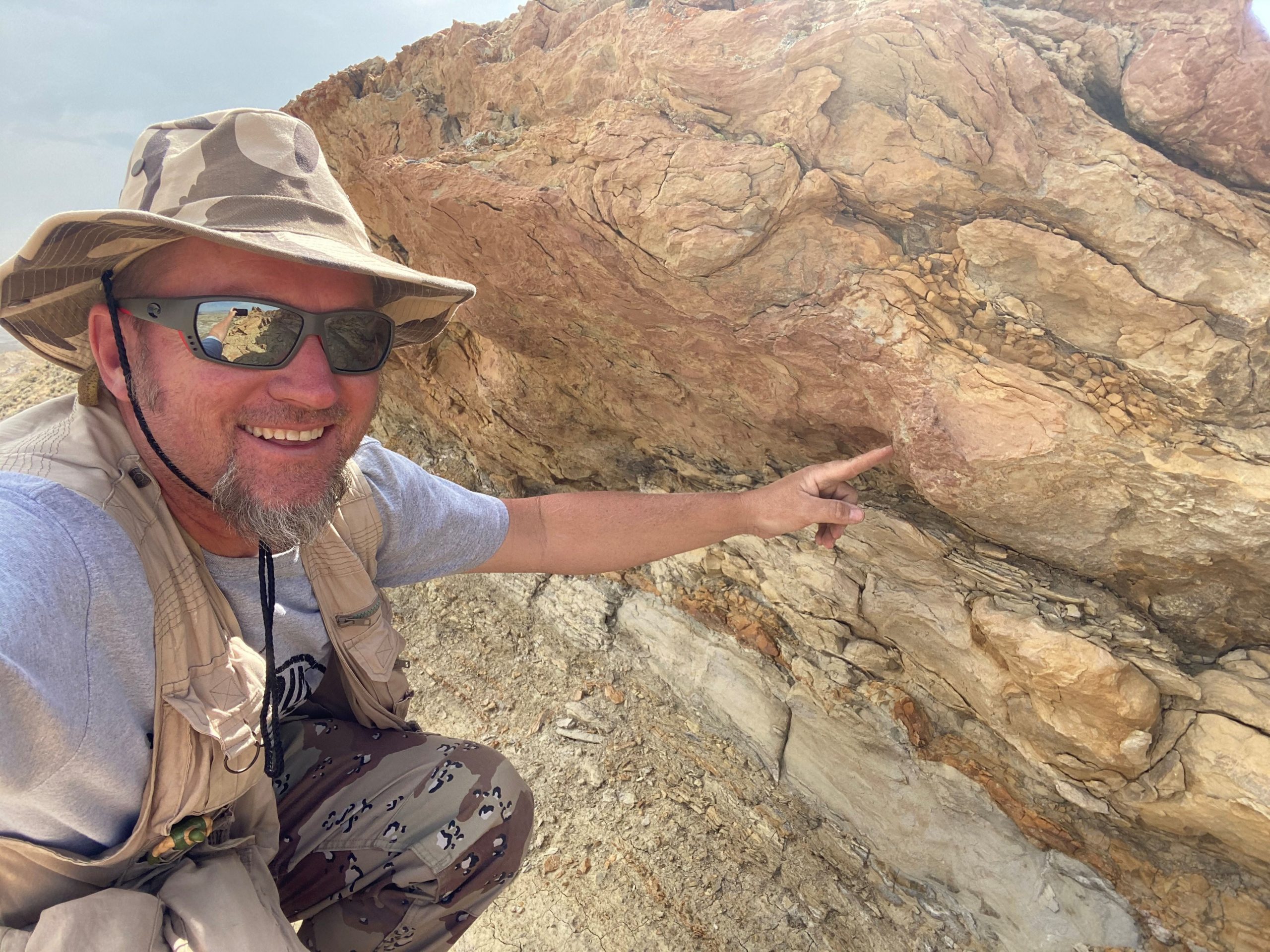 Anton Wroblewski points to an underprint made 58 million years ago by a heavy mammal (likely Coryphodon) walking on the deltaic deposits above. Underprints form when sediment is displaced downward by footsteps from heavy animals.