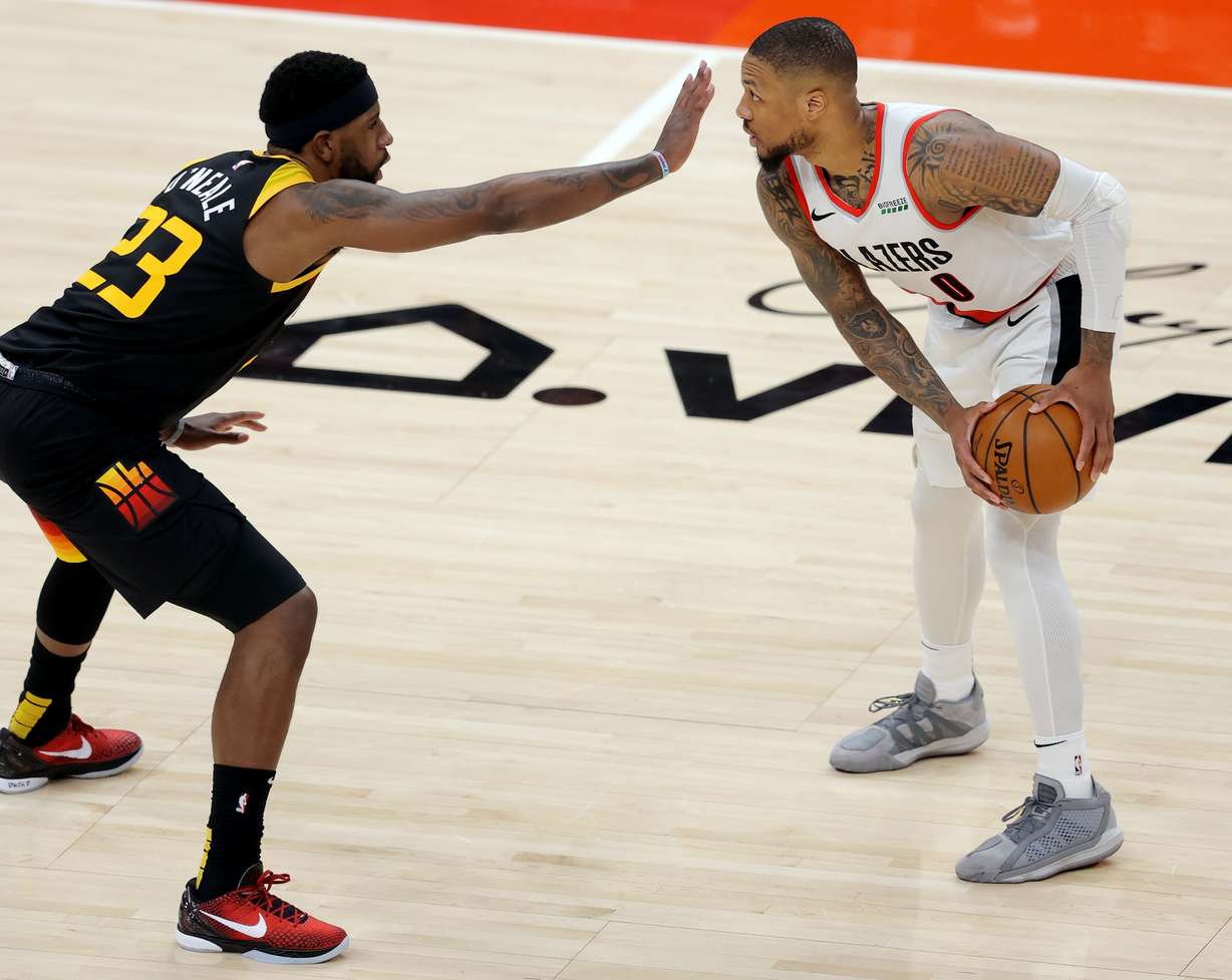 Utah Jazz forward Royce O'Neale (23) sticks his hand in front of Portland Trail Blazers guard Damian Lillard (0) as the Utah Jazz and the Portland Trail Blazers play an NBA basketball game at Vivint Arena in Salt Lake City on Wednesday, May 12, 2021. Portland won 105-98, the Trail Blazers' fifth straight win and back-to-back losses for the Jazz.