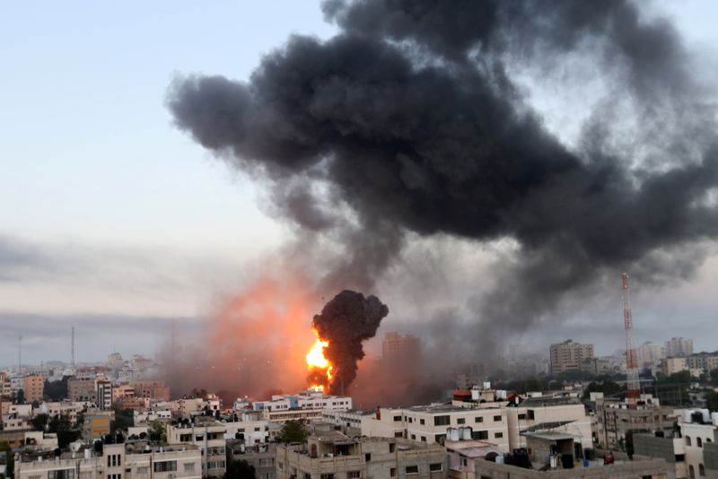 Smoke and flames rise during Israeli air strikes amid a flare-up of Israeli-Palestinian violence, in Gaza, May 12. REUTERS/Ibraheem Abu Mustafa