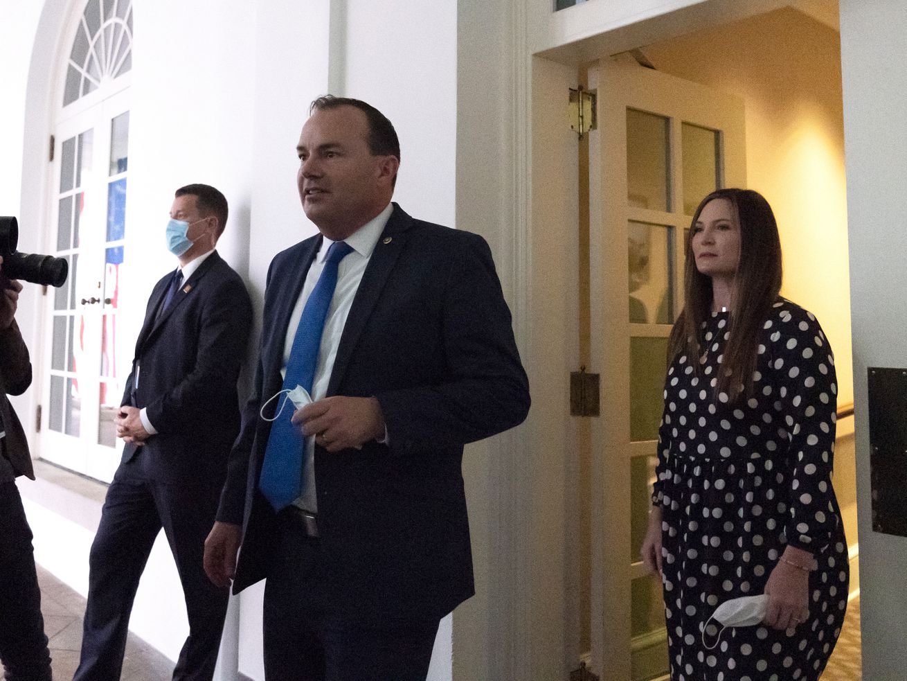 Sen. Mike Lee, R-Utah, center, steps out of the West
Wing to watch as then-President Donald Trump announces Judge Amy
Coney Barrett as his nominee to the Supreme Court, in the Rose
Garden at the White House in Washington on Saturday, Sept. 26,
2020.