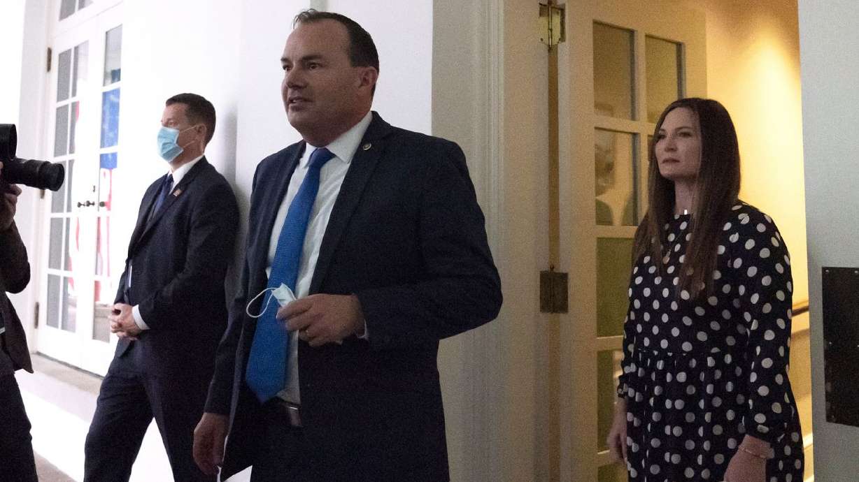 Sen. Mike Lee, R-Utah, center, steps out of the West
Wing to watch as then-President Donald Trump announces Judge Amy
Coney Barrett as his nominee to the Supreme Court, in the Rose
Garden at the White House in Washington on Saturday, Sept. 26,
2020.