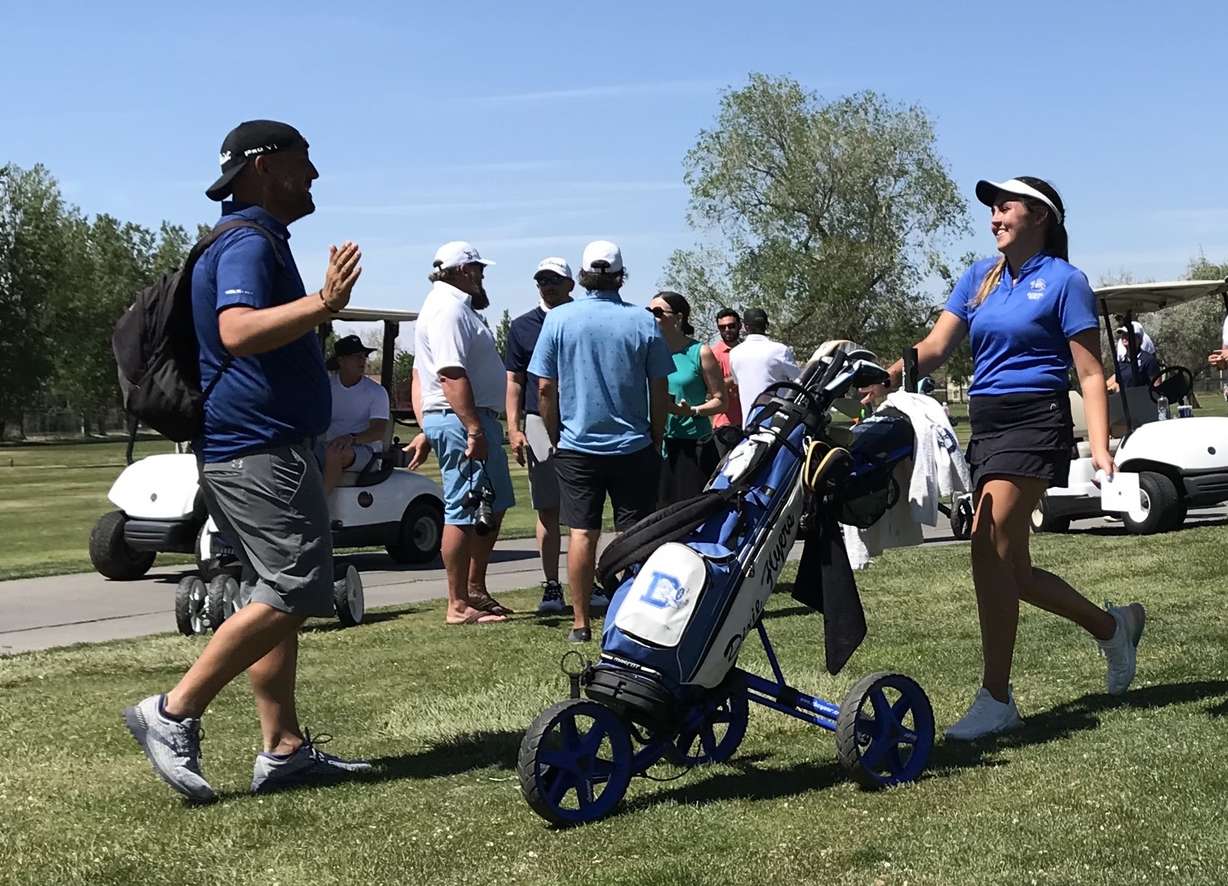 Dixie's Annabelle Millard hugs her father after soaring to medalist honors following the Class 3A state meet, Thursday, May 13, 2021 at Meadowbrook golf course in Taylorsville.