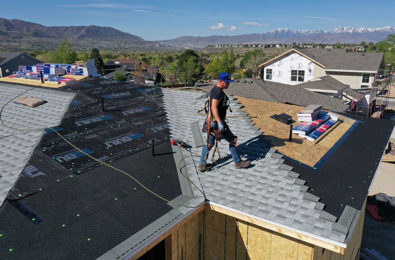 Robert Zavala roofs a home under construction in Sandy
on Wednesday, May 5, 2021.