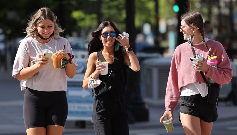 Mikayla Melchert, left, Kinzie Hague and Taylor
Brockhoff go maskless in Salt Lake City on Friday, May 14, 2021.
Federal guidelines say masks are no longer needed in most
situations for Americans who are fully vaccinated against
COVID-19.