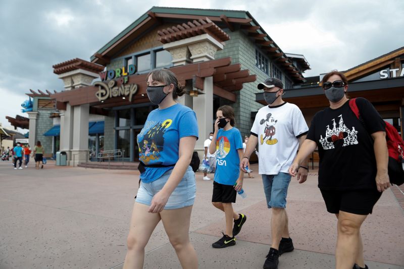FILE PHOTO: Summer Selmon, her brother Levi, and their parents Dave and Brandi wear face masks while visiting the Disney Springs shopping and dining district during their vacation at Walt Disney World during a phased reopening from coronavirus disease (COVID-19) restrictions in Lake Buena Vista, Florida, U.S. July 11, 2020. REUTERS/Octavio Jones
