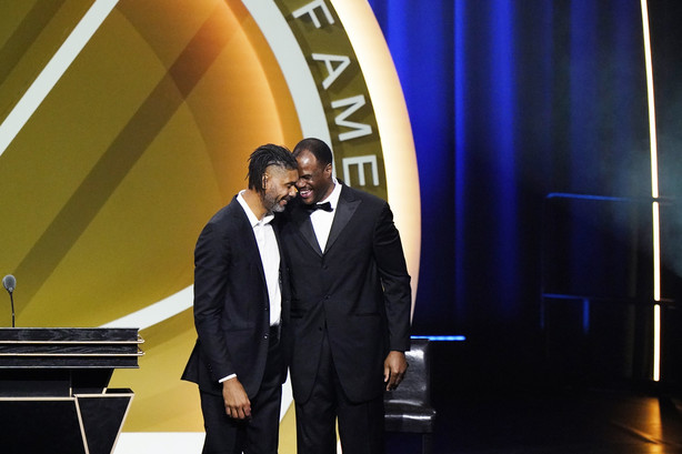 Tim Duncan, left, smiles with presenter David Robinson after being enshrined with the 2020 Basketball Hall of Fame class Saturday, May 15, 2021, in Uncasville, Conn.