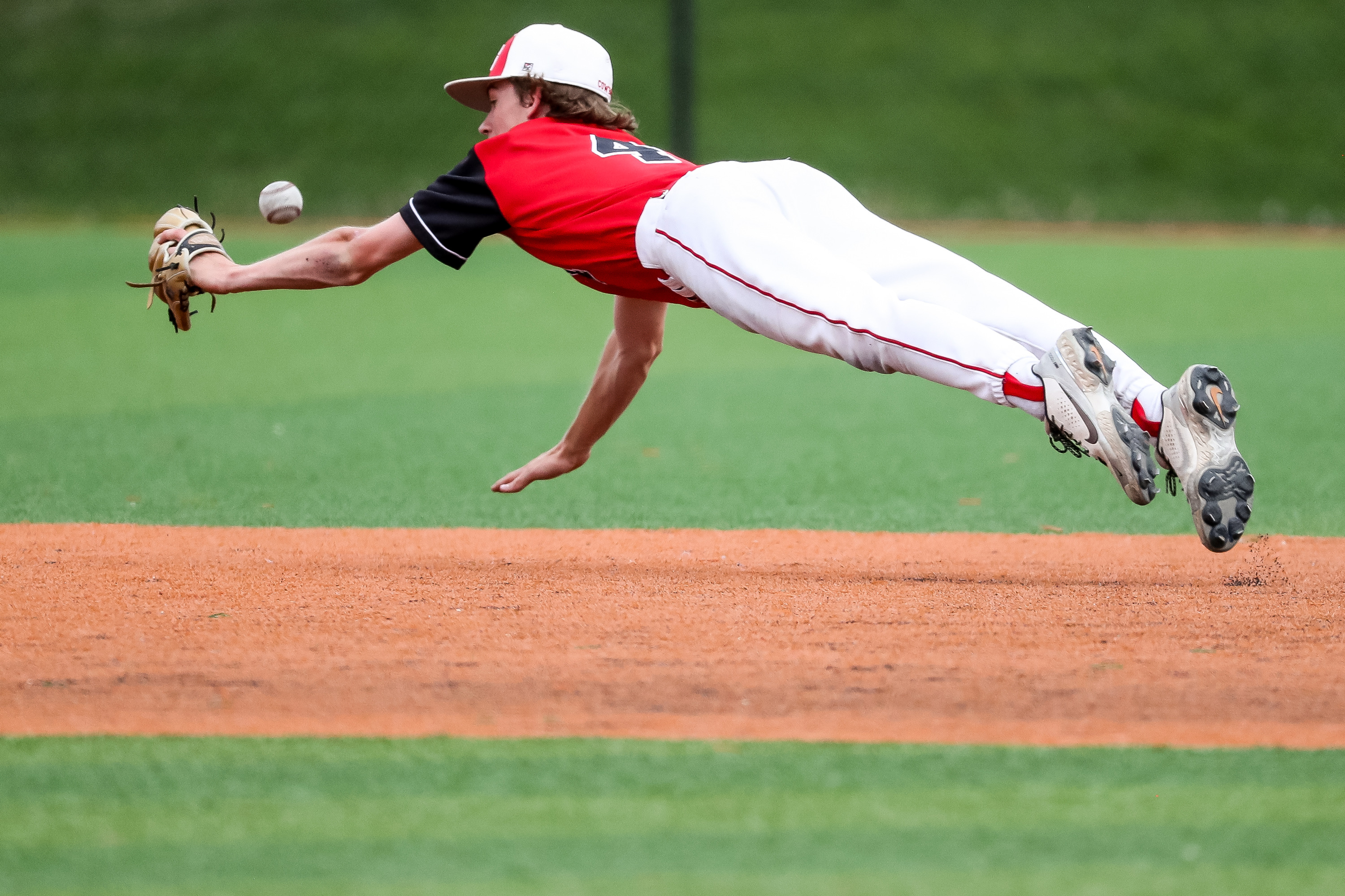 Grantsville shortstop Jace Sandberg comes up short on a fast grounder, allowing Carbon batter Derick Robison to single in the first of two 3A baseball championship games at Salt Lake Community College in West Jordan on Saturday, May 15, 2021.