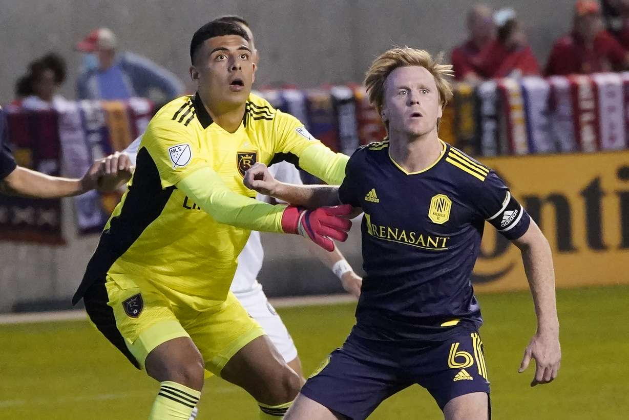 Real Salt Lake goalkeeper David Ochoa, left, and Nashville SC midfielder Dax McCarty (6) battle for position during the second half of an MLS soccer match Saturday, May 15, 2021, in Sandy.