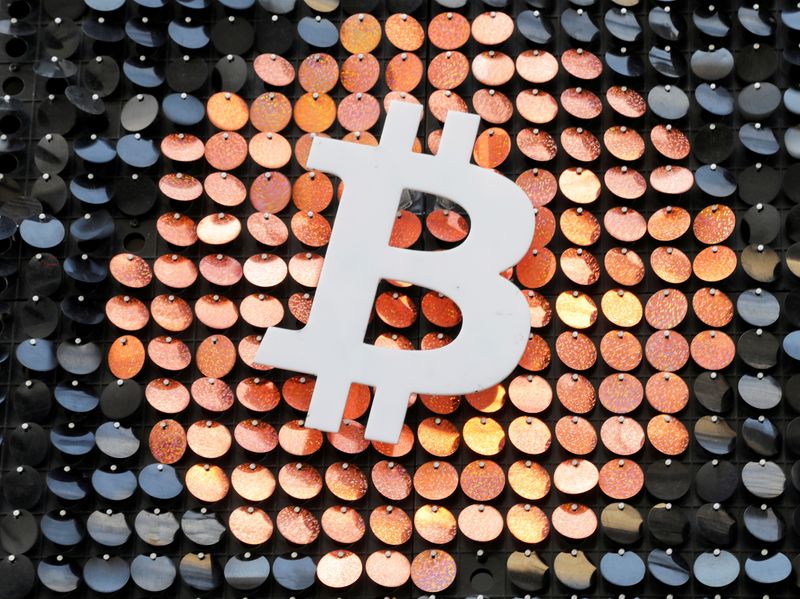 FILE PHOTO: The logo of the Bitcoin digital currency is seen in a shop in Marseille, France, February 7, 2021. REUTERS/Eric Gaillard/File Photo/File Photo