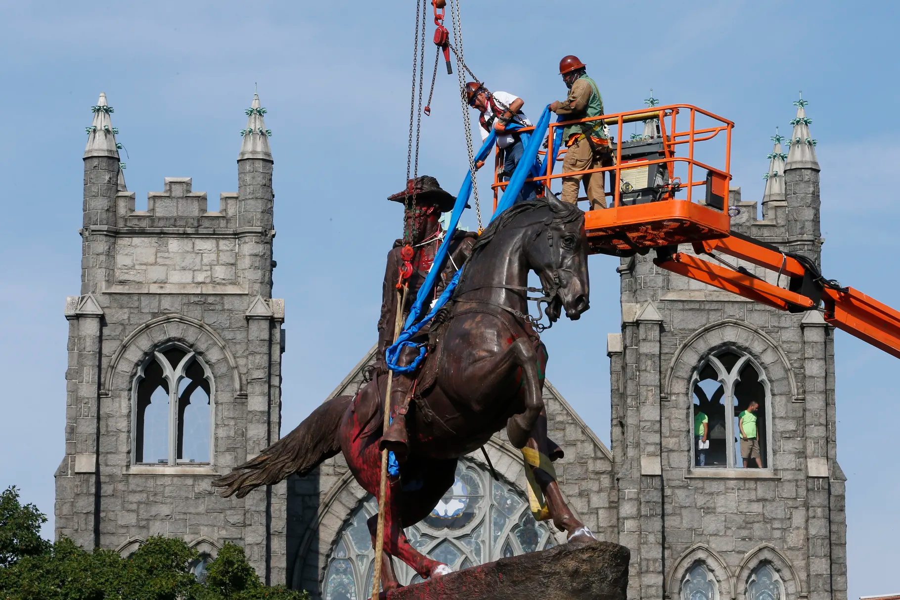 In this July 7, 2020, file photo, crews attach straps to the statue of Confederate Gen. J.E.B. Stuart on Monument Avenue in Richmond, Va. At least 160 Confederate symbols were taken down or moved from public spaces in 2020. From literature to sculpture, can anything old survive in our current political and cultural climate?
