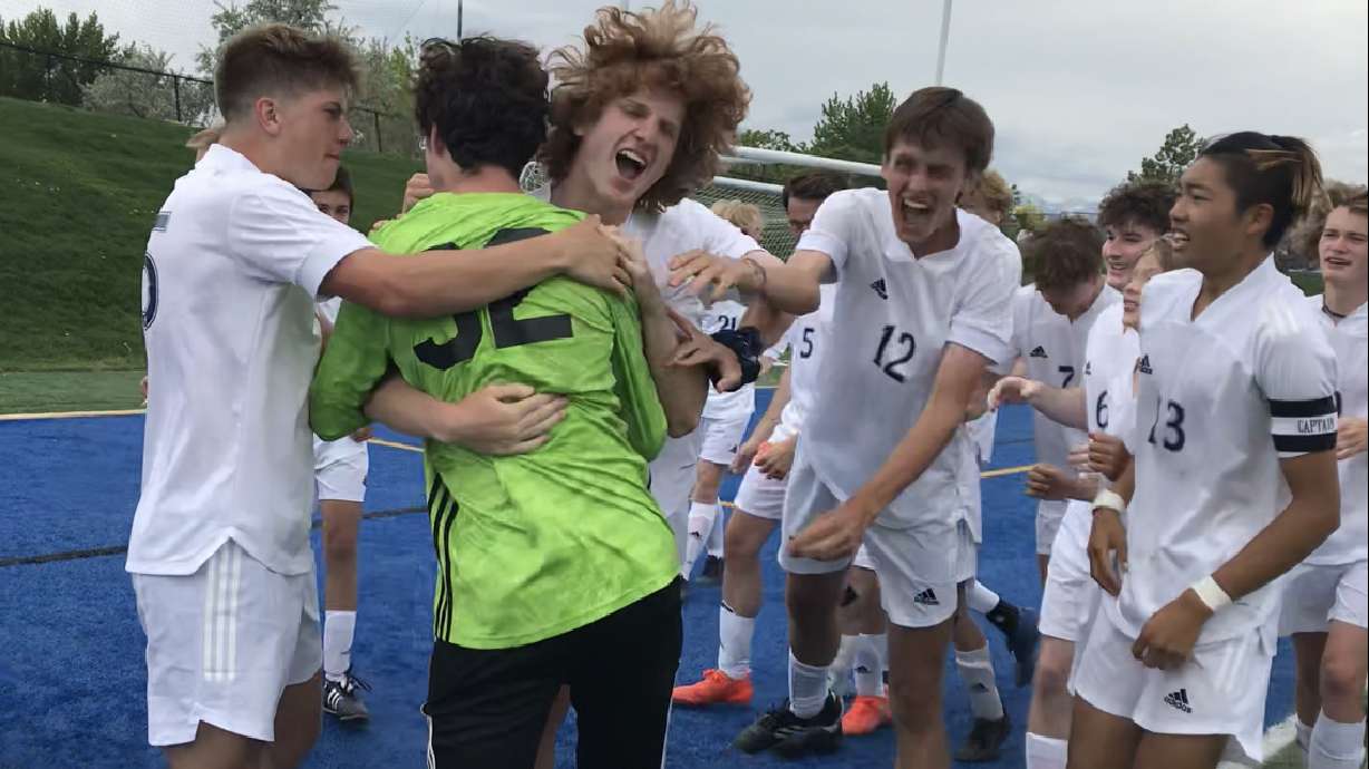 Waterford goalkeeper Atticus Benson is mobbed by his teammates after saving three penalties during a shootout to move the Ravens by top-seeded St. Joseph's in a UHSAA Class 2A boys soccer state semifinal Monday, May 17, 2021 at Juan Diego.
