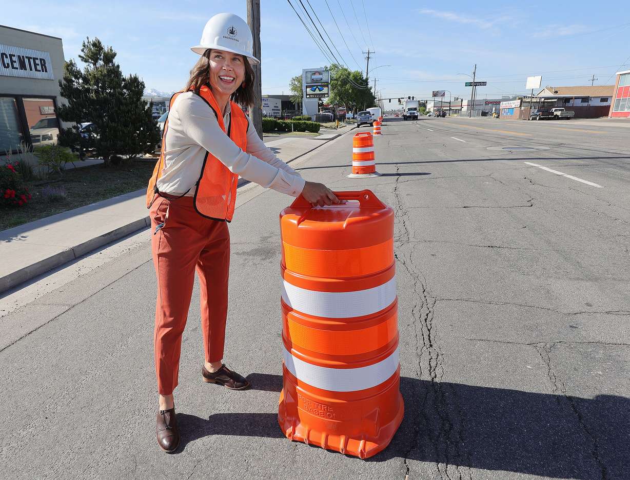 Salt Lake City Mayor Erin Mendenhall marks the start of the 300 West reconstruction project by carrying a barrier to the street in Salt Lake City on Tuesday, May 18, 2021. The street will be reconstructed from 2100 South to 900 South.