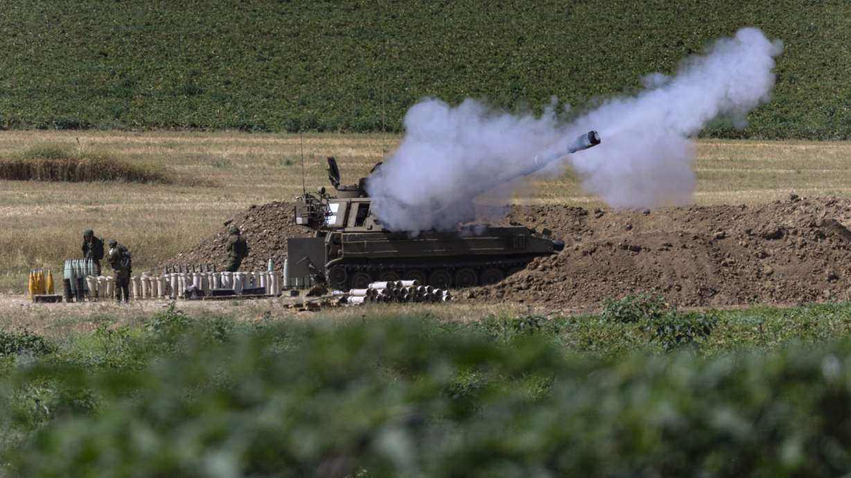 An Israeli artillery unit fires toward targets in Gaza Strip, at the Israeli Gaza border, Tuesday, May 18, 2021. (AP Photo/Tsafrir Abayov)