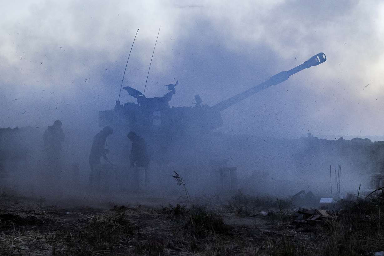 An Israeli artillery unit fires toward targets in Gaza Strip, at the Israeli Gaza border, Tuesday, May 18, 2021. (AP Photo/Tsafrir Abayov)