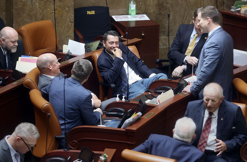 Lawmakers chat without masks during a special session
of the Legislature at the Capitol in Salt Lake City on Wednesday,
May 19, 2021.
