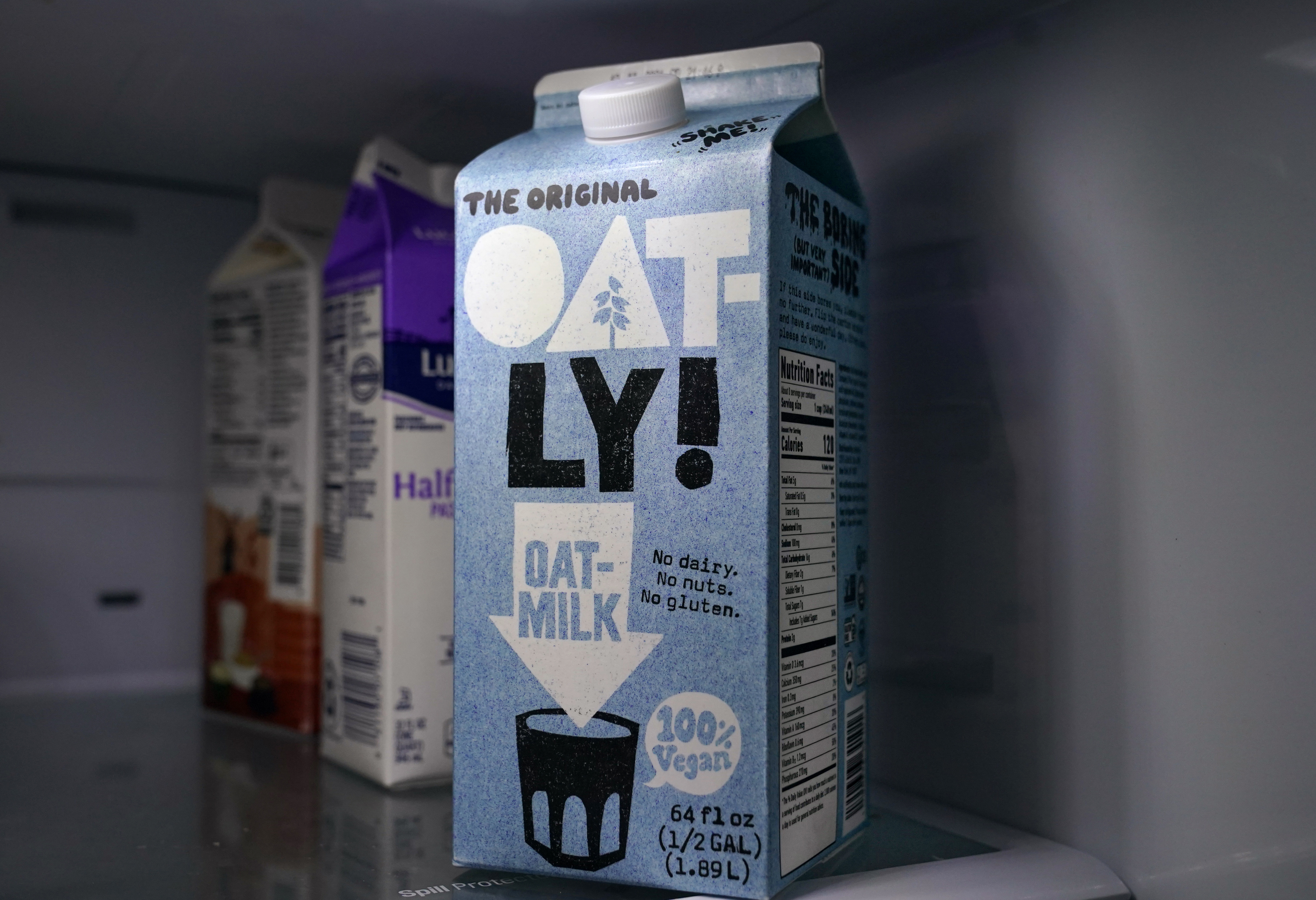 A carton of Oatly oat milk sits in a home refrigerator, May 18, 2021, in Bellingham, Wash. Oatly recently joined a climate change awareness campaign.