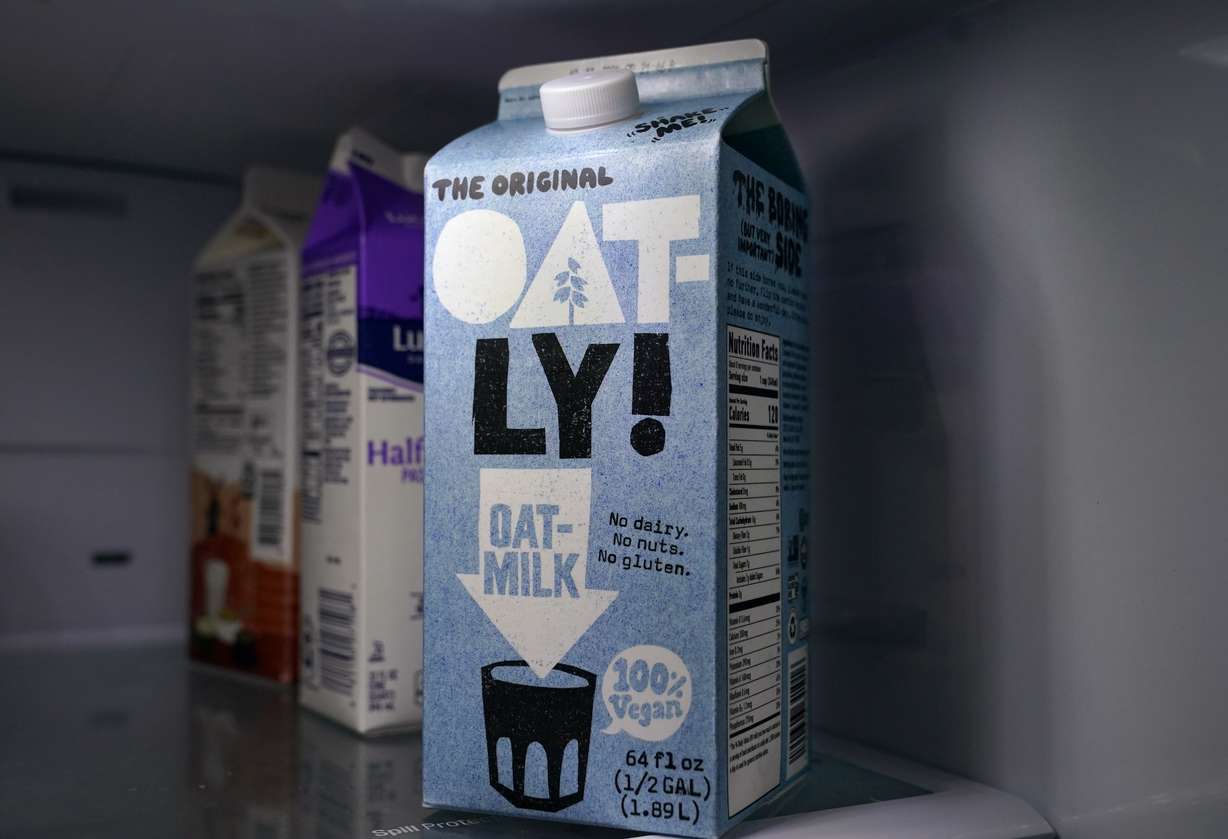 A carton of Oatly oat milk sits in a home refrigerator, May 18, 2021, in Bellingham, Wash. Oatly recently joined a climate change awareness campaign.