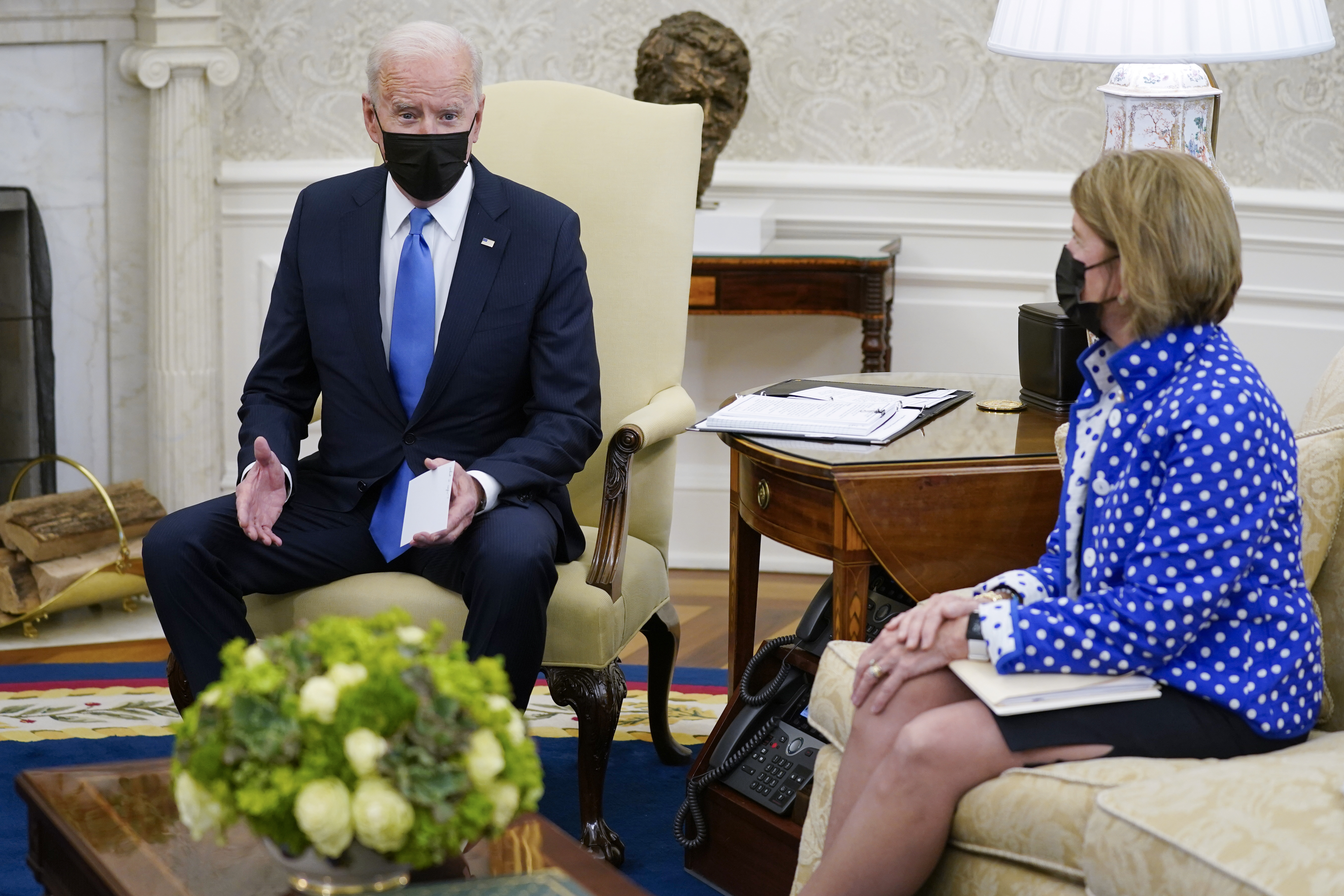 In this May 13, 2021, file photo, Sen. Shelley Moore Capito, R-W.Va., right, listens as President Joe Biden speaks during a meeting with Republican Senators in the Oval Office of the White House in Washington. The two senators from West Virginia are playing central roles in Biden's infrastructure plans. Democrat Joe Manchin is a crucial 50th vote for his party on Biden's proposals.