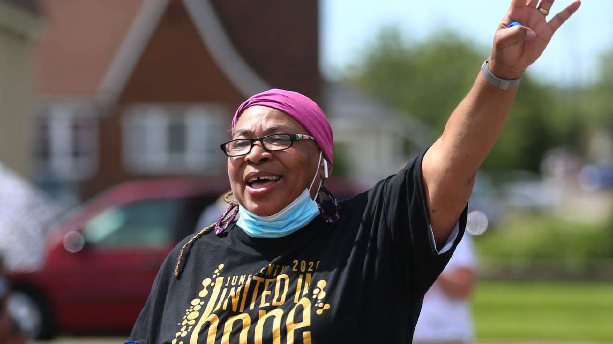 Betty Sawyer talks to a group before they get in their
cars to celebrate Juneteenth by caravanning on the streets in Ogden
on June 20, 2020.