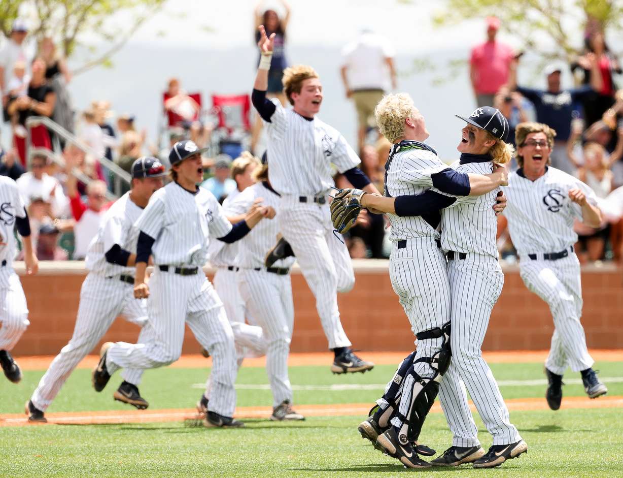 Snow Canyon catcher Mason Strong and pitcher Luke Anderson celebrate after defeating Mountain Crest in the 4A baseball championship at Salt Lake Community College in West Jordan on Saturday, May 22, 2021.