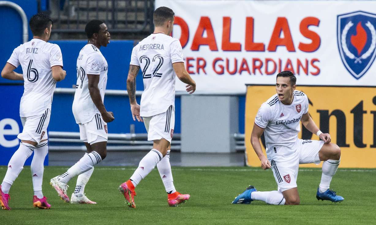 Real Salt Lake forward Rubio Rubin, right, is congratulated by teammates after scoring a goal during the first half of an MLS soccer match against FC Dallas, Saturday, May 22, 2021, in Frisco, Texas. (AP Photo/Brandon Wade)