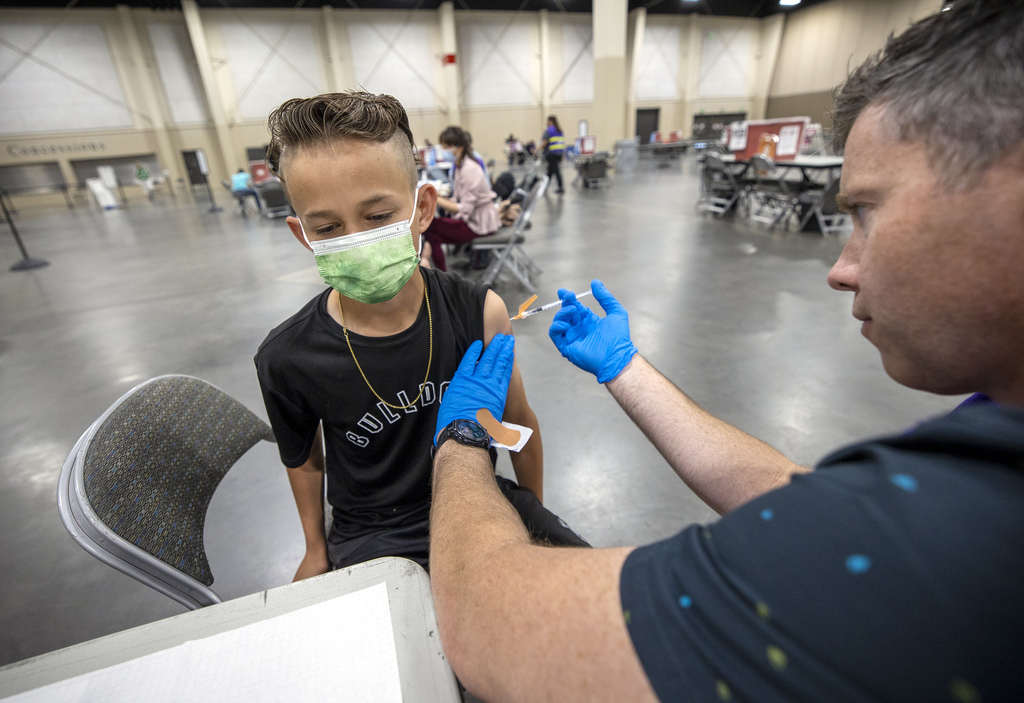Carson Atkinson, 12, is gets a COVID-19 vaccination at the Mountain America Exposition Center in Sandy on Tuesday, May 18, 2021.