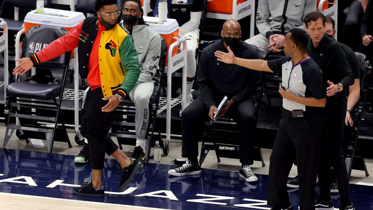 Utah Jazz guard Donovan Mitchell (45) is directed to the end of the bench by referee James Capers (19) as the Utah Jazz and the Memphis Grizzlies play in game one of their NBA playoff series at Vivint Arena in Salt Lake City on Sunday, May 23, 2021.