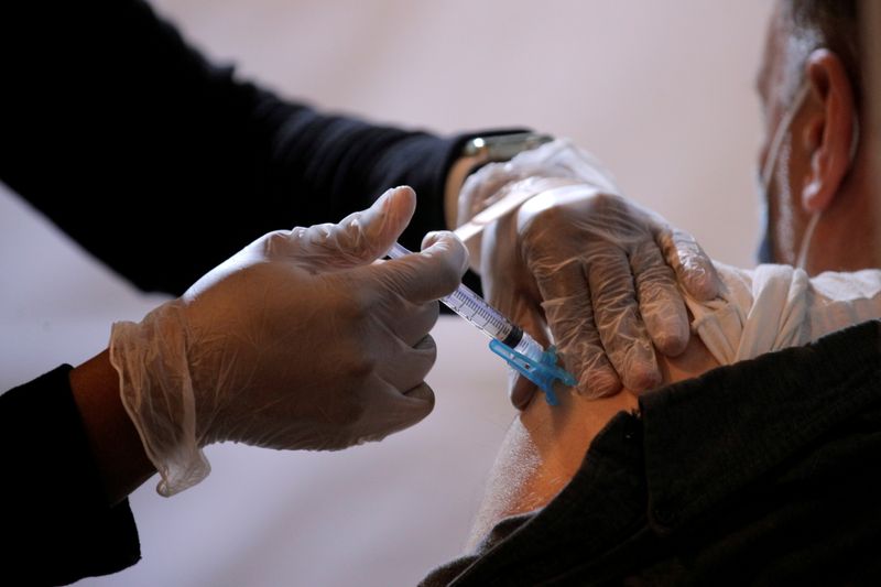 FILE PHOTO: A commuter receives a shot of the Johnson & Johnson vaccine for the coronavirus disease (COVID-19) during the opening of MTA's public vaccination program at a subway station in the Brooklyn borough of New York City, New York, U.S., May 12, 2021. REUTERS/Brendan McDermid