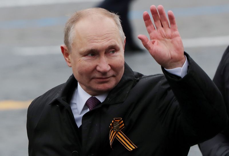 FILE PHOTO: Russian President Vladimir Putin waves while walking along Red Square after a military parade on Victory Day, in central Moscow, Russia May 9, 2021. REUTERS/Evgenia Novozhenina