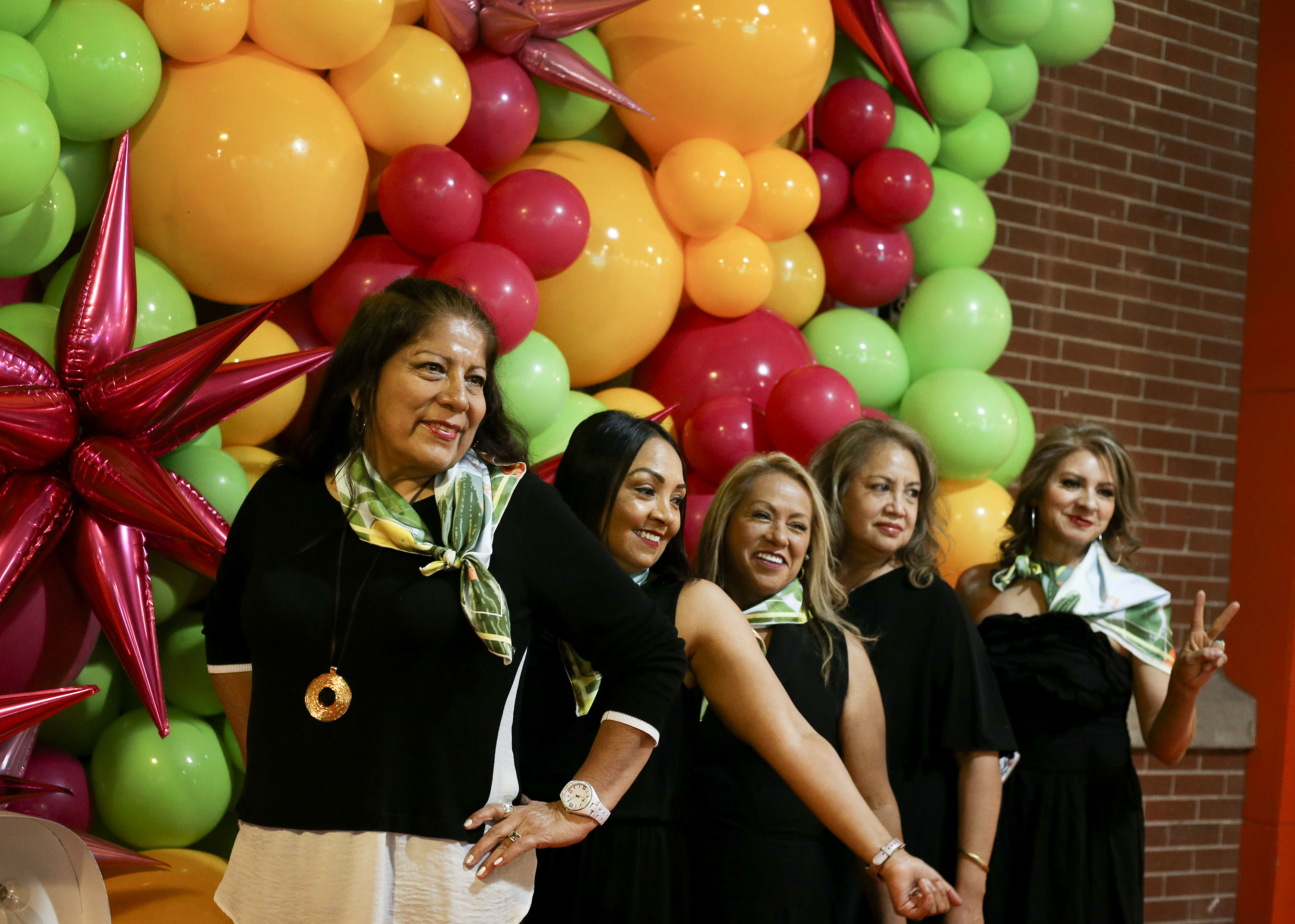 Cancer survivor Nora Serrano, right, Sara Carbajal, health program director for Alliance Community Services, and cancer survivors Beneranda Marquez and Ana Dant take photos during the Utah Latin Runway & Trunkshow at The Gateway in Salt Lake City on Saturday, May 22, 2021. Utah Latin Runway partnered with Alliance Community Services and its cancer survivors support group "Triunfadoras," which provides help to Hispanic women, their families and caregivers. Utah Latin Runway will donate a percentage of ticket sales to Alliance Community Services.
