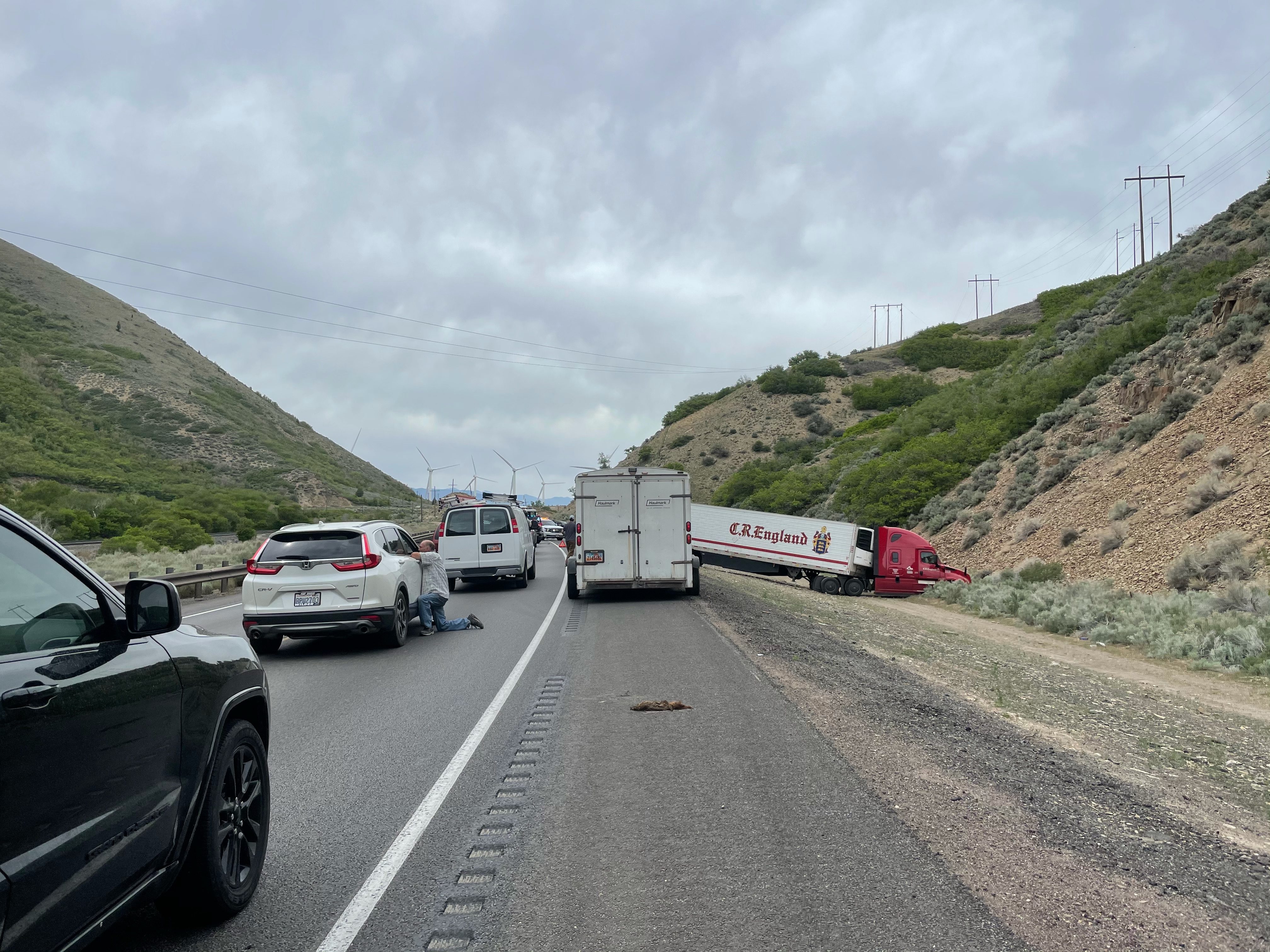 Cars wait while emergency crews respond to a crash between a semitruck and vehicle outside of Spanish Fork on Tuesday, May 25, 2021.