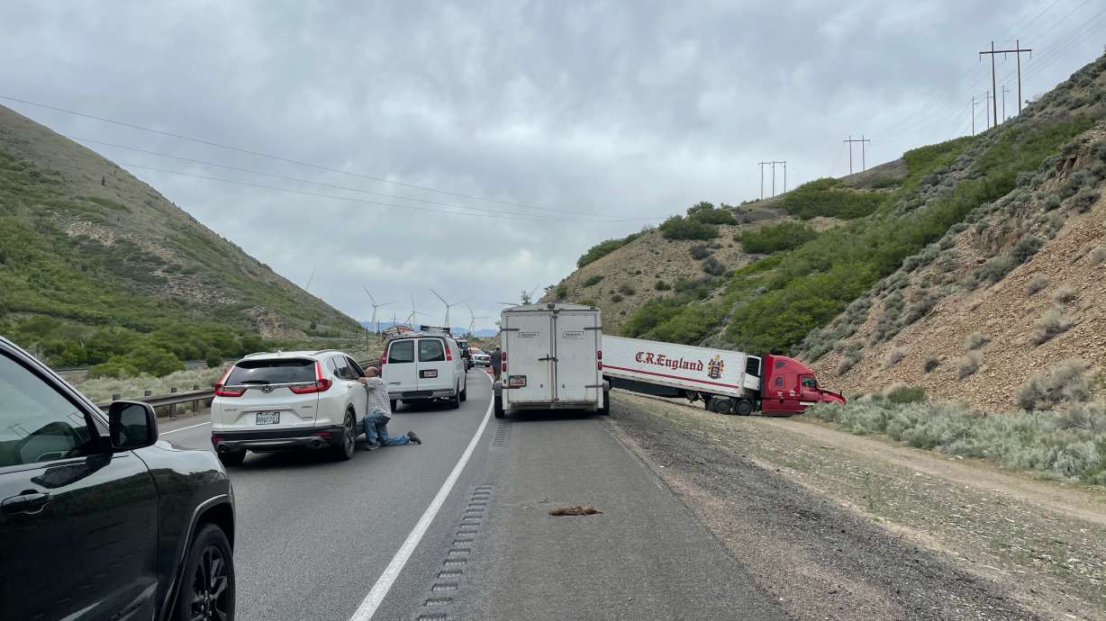 Cars wait while emergency crews respond to a crash between a semitruck and vehicle outside of Spanish Fork on Tuesday, May 25, 2021.
