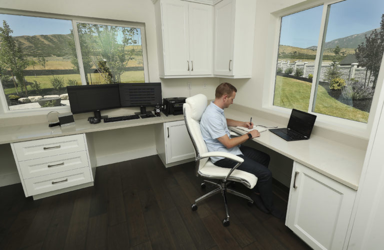 Tyson Oldham works in his home office with a view of the mountains in Highland on Friday, Aug. 14, 2020.