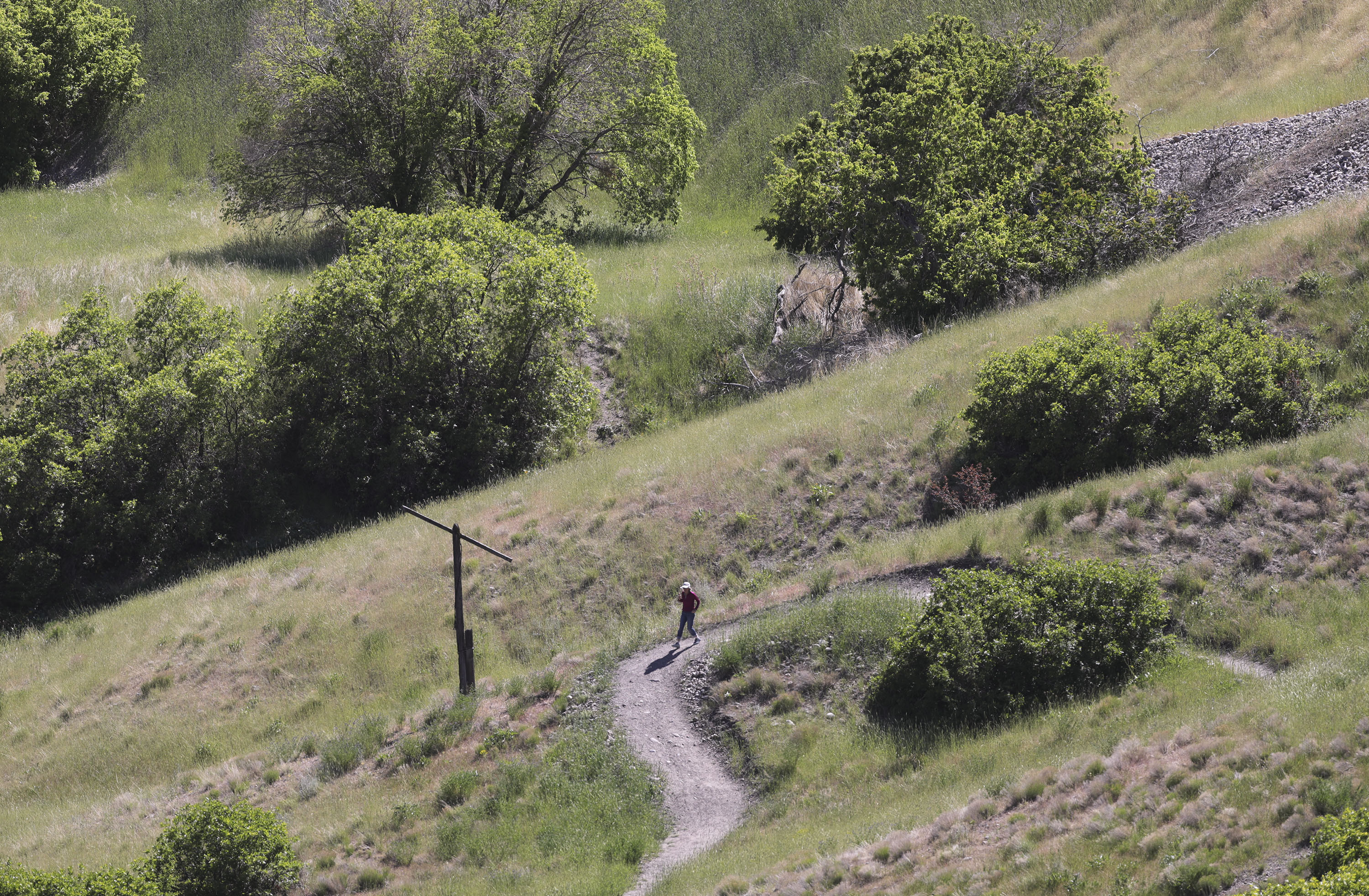 A woman walks in City Creek Canyon in Salt Lake City on Wednesday, May 26, 2021. One hundred percent of Utah is in drought with 90% of the state in extreme drought.