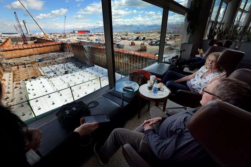 Drew and Jan Simmons, of Twin Falls, Idaho, watch
construction workers as they wait for a flight at the new Salt Lake
City International Airport on Monday, May 24, 2021.