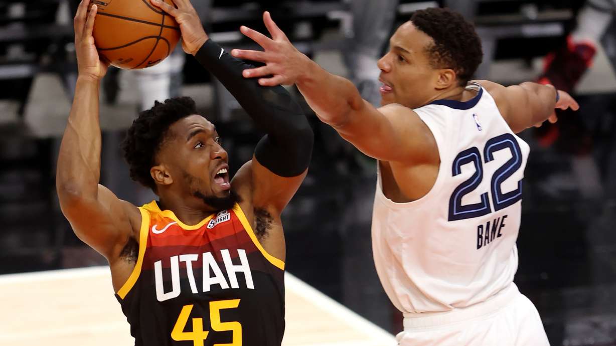 Utah Jazz guard Donovan Mitchell (45) goes at Memphis Grizzlies guard Desmond Bane (22) for a basket as the Utah Jazz and Memphis Grizzlies play Game 2 of their NBA playoffs first round series at Vivint Arena in Salt Lake City on Wednesday, May 26, 2021.