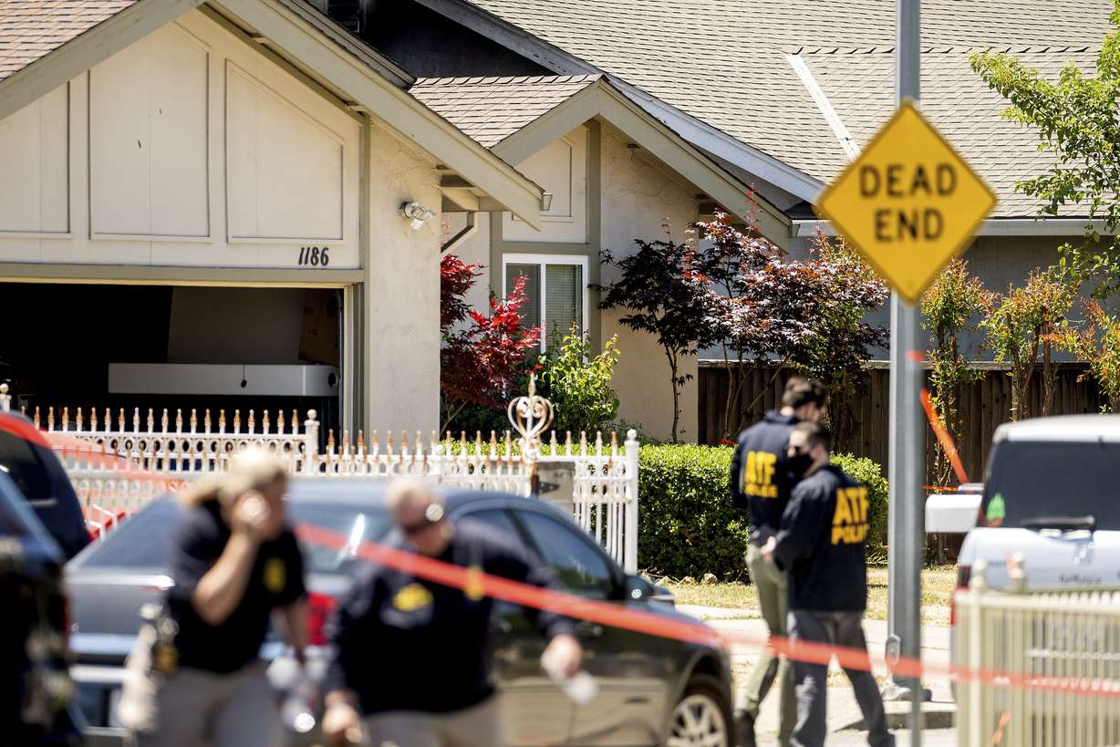 FBI agents approach a home, rear, being investigated in connection to a shooting at a Santa Clara Valley Transportation Authority (VTA) facility on Wednesday, May 26, 2021, in San Jose, Calif.